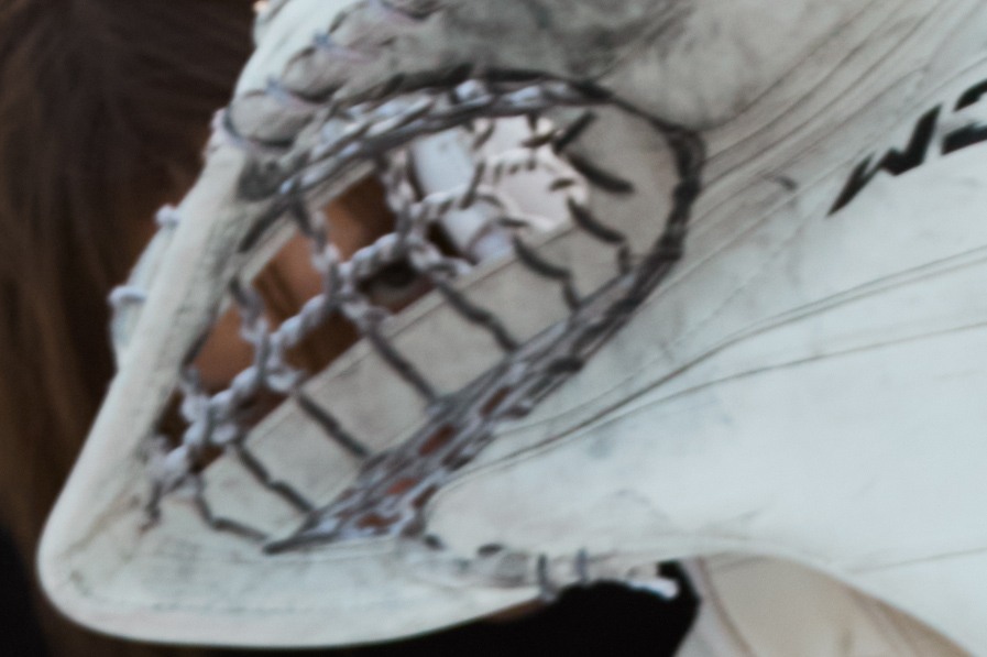 Close-up of the worn surface and lacing of a white goalkeeper pad